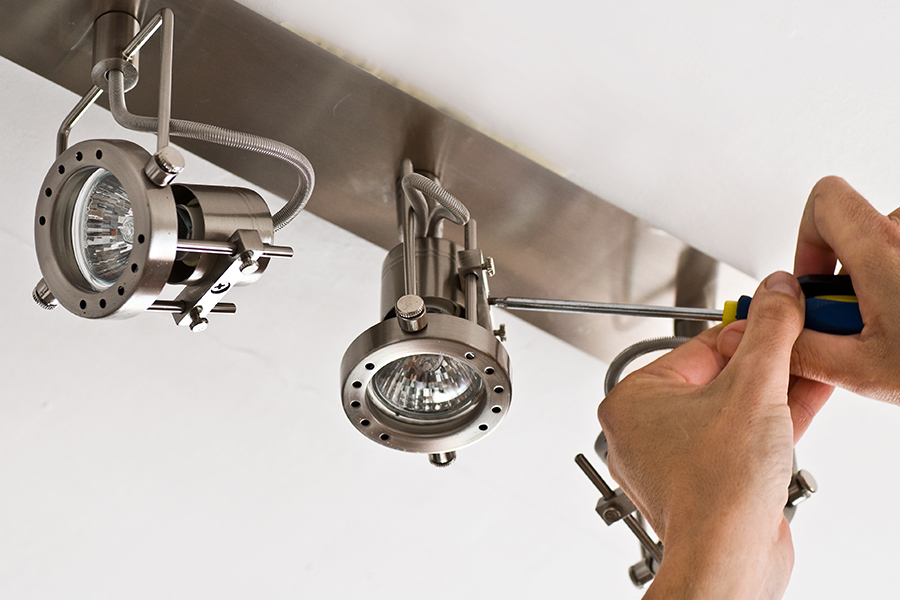 electrician hands with screwdriver close up installing lights at ceiling arlington tx